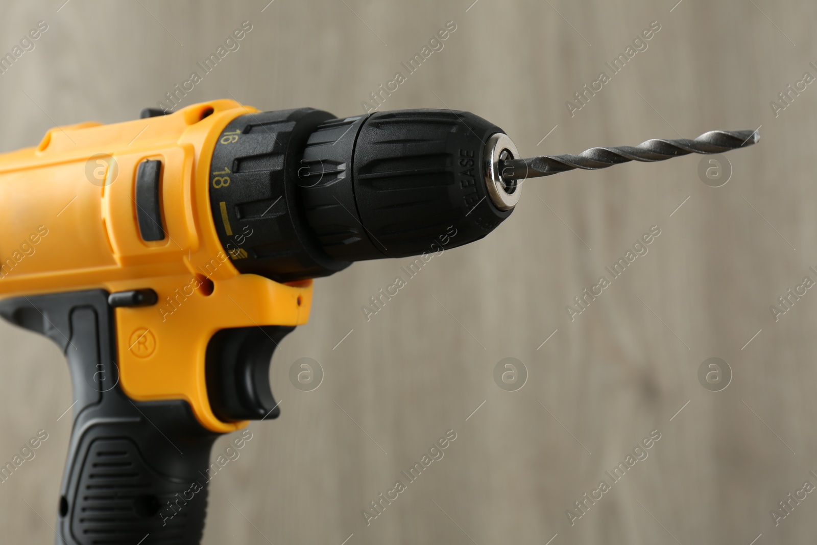 Photo of One cordless electric drill against blurred background