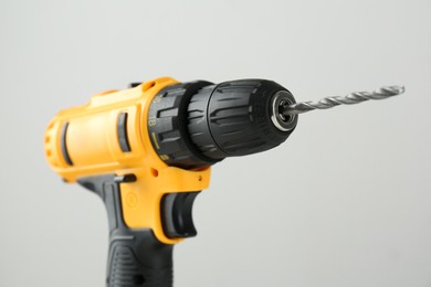 One cordless electric drill on light grey background