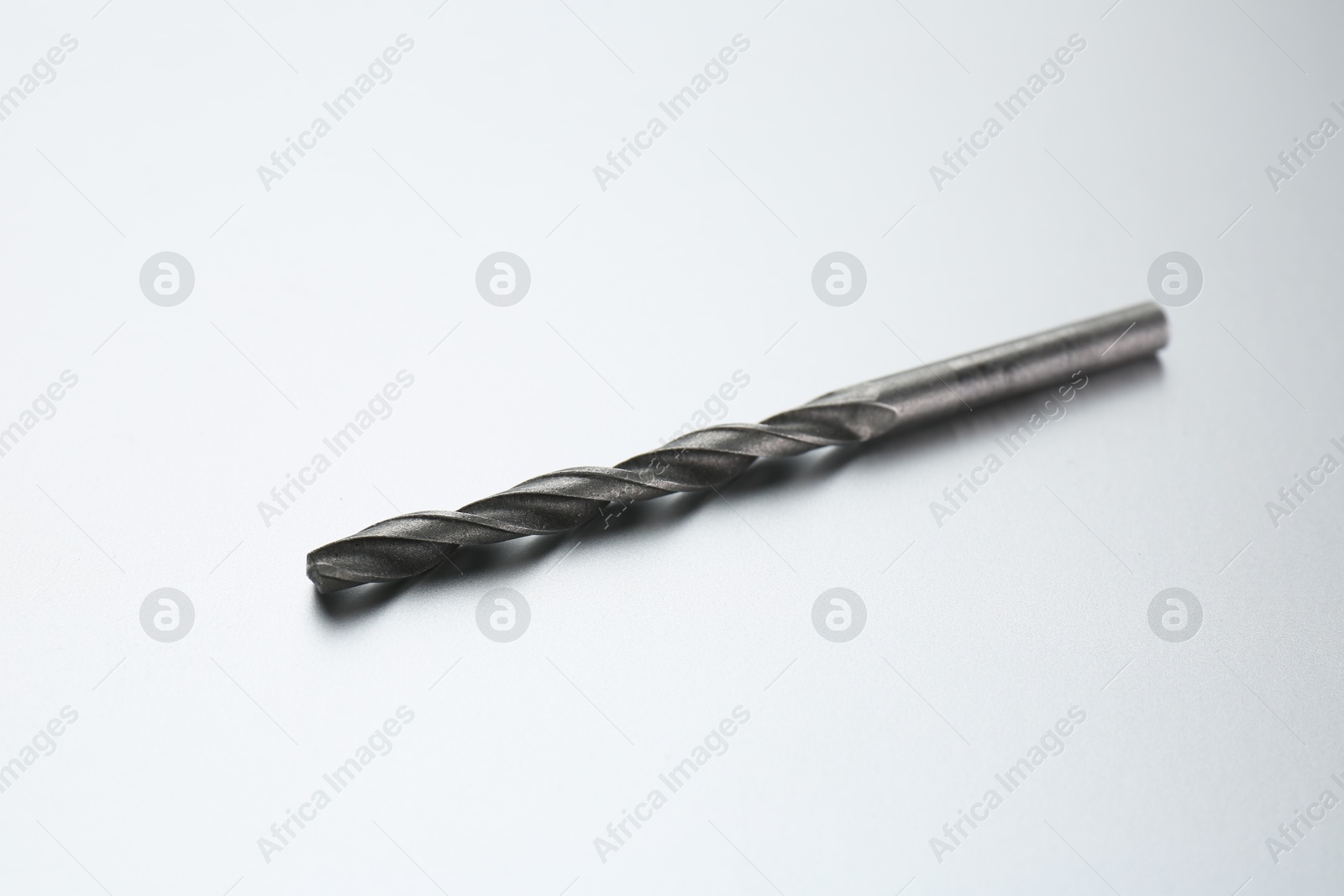 Photo of One drill bit on light grey background