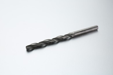 Photo of One drill bit on light grey background