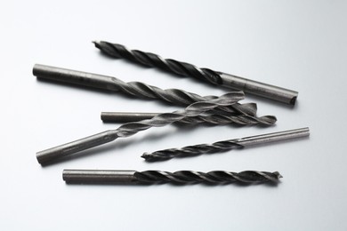 Photo of Many different drill bits on light grey background