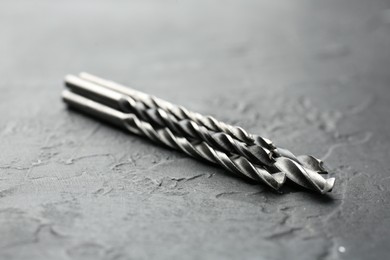 Photo of Three different drill bits on grey table