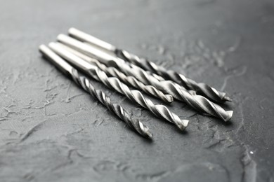 Photo of Many different drill bits on grey table