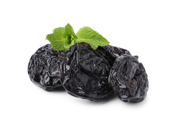 Photo of Tasty dried plums (prunes) and mint leaves isolated on white
