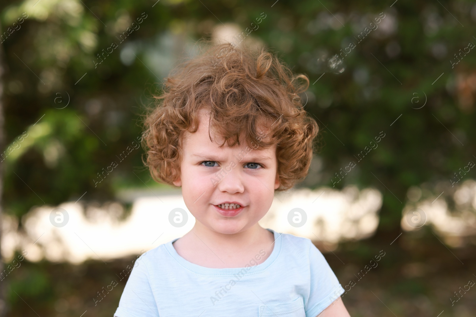 Photo of Portrait of little boy outdoors. Cute child