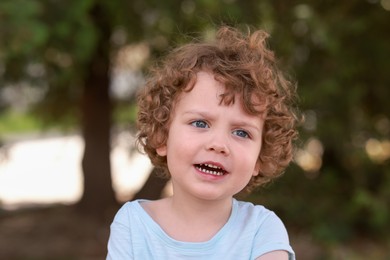 Photo of Portrait of little boy outdoors. Cute child