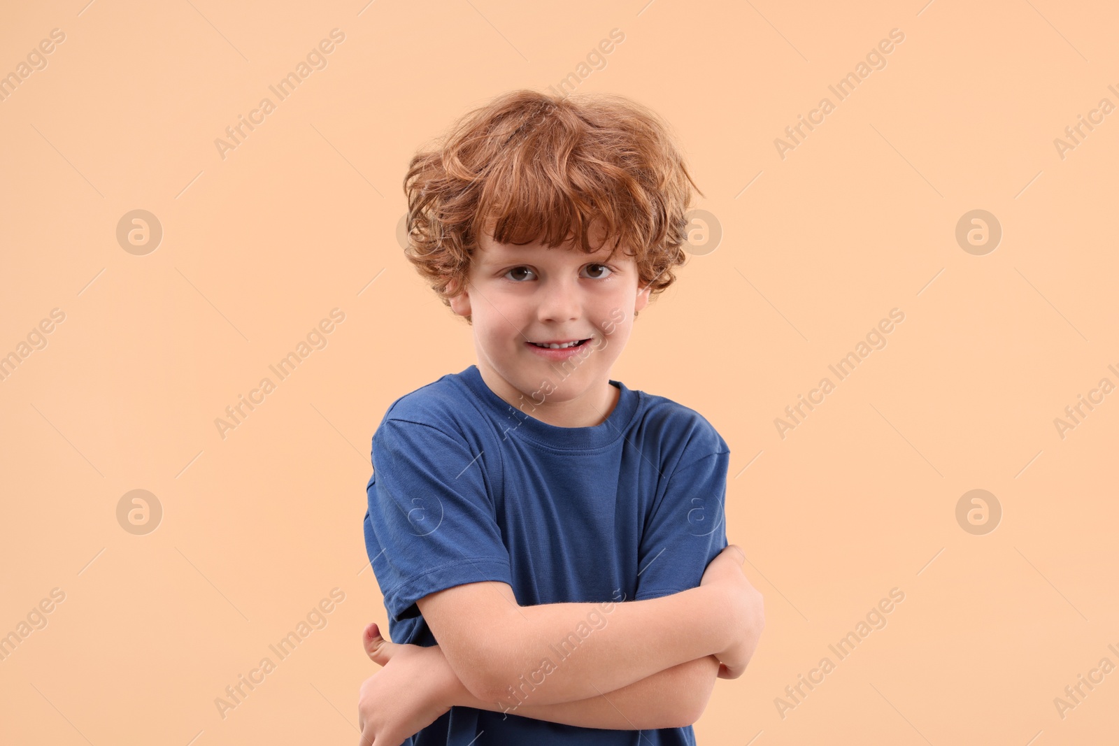 Photo of Portrait of cute little boy on beige background