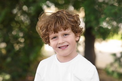 Photo of Portrait of little boy outdoors. Cute child