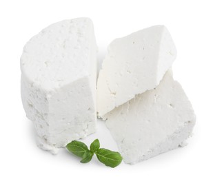 Photo of Fresh ricotta (cream cheese) and basil isolated on white