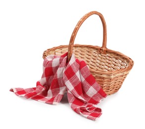 Photo of One picnic wicker basket with checkered napkin isolated on white