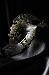 Beautiful golden carnival mask on black background, closeup