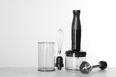 Hand blender kit on gray table against white background, space for text