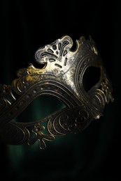 Photo of Beautiful carnival mask on black background, closeup