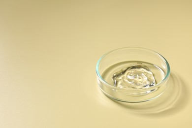 Photo of Petri dish with sample on beige background, space for text