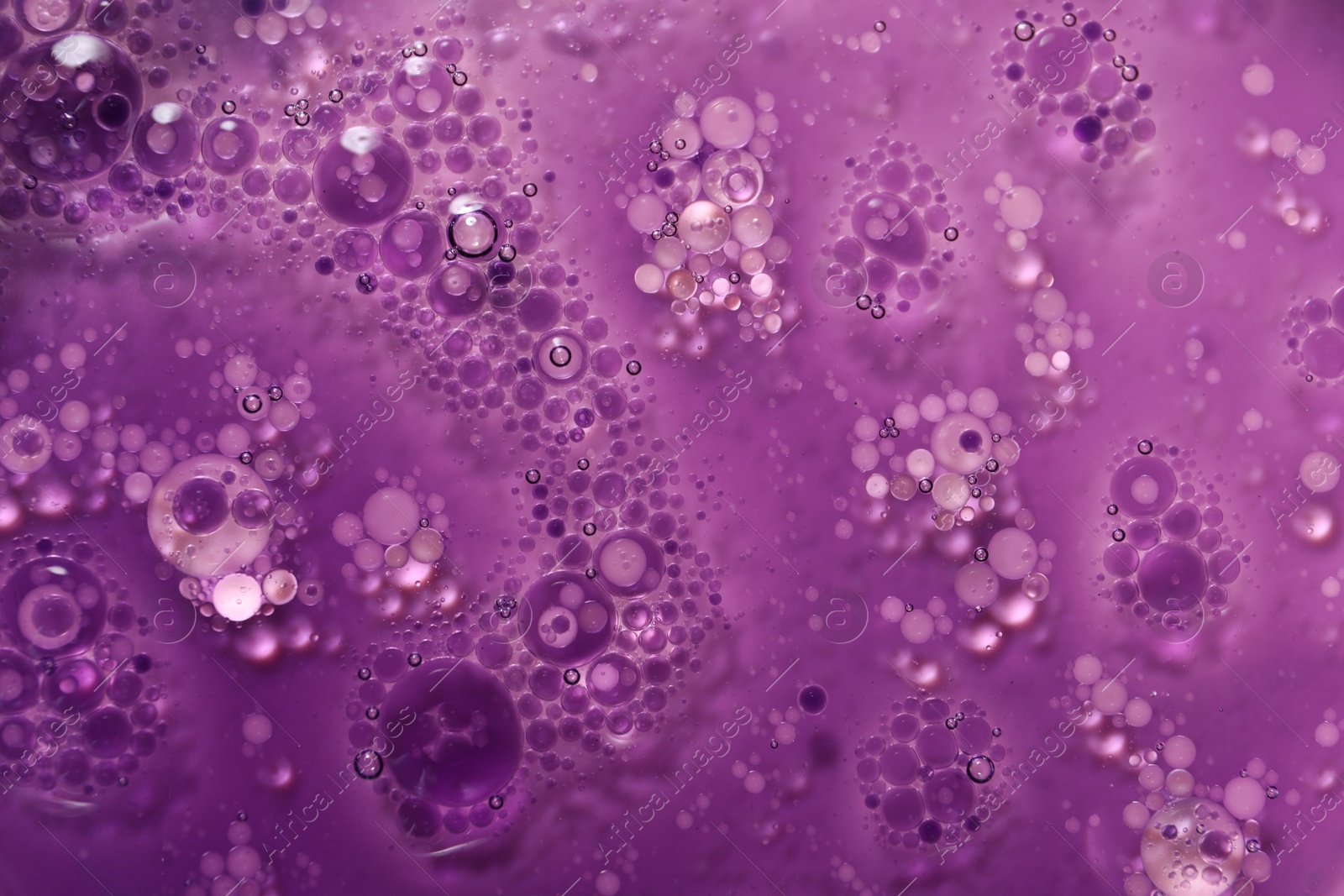 Photo of Bright purple liquid as background, top view