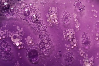 Photo of Bright purple liquid as background, top view