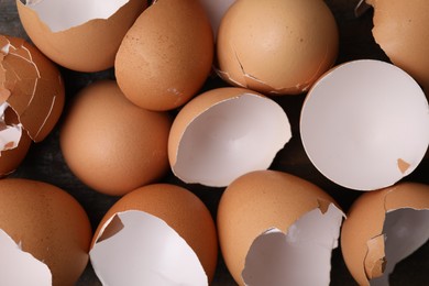 Photo of Pieces of broken eggshells on table, top view