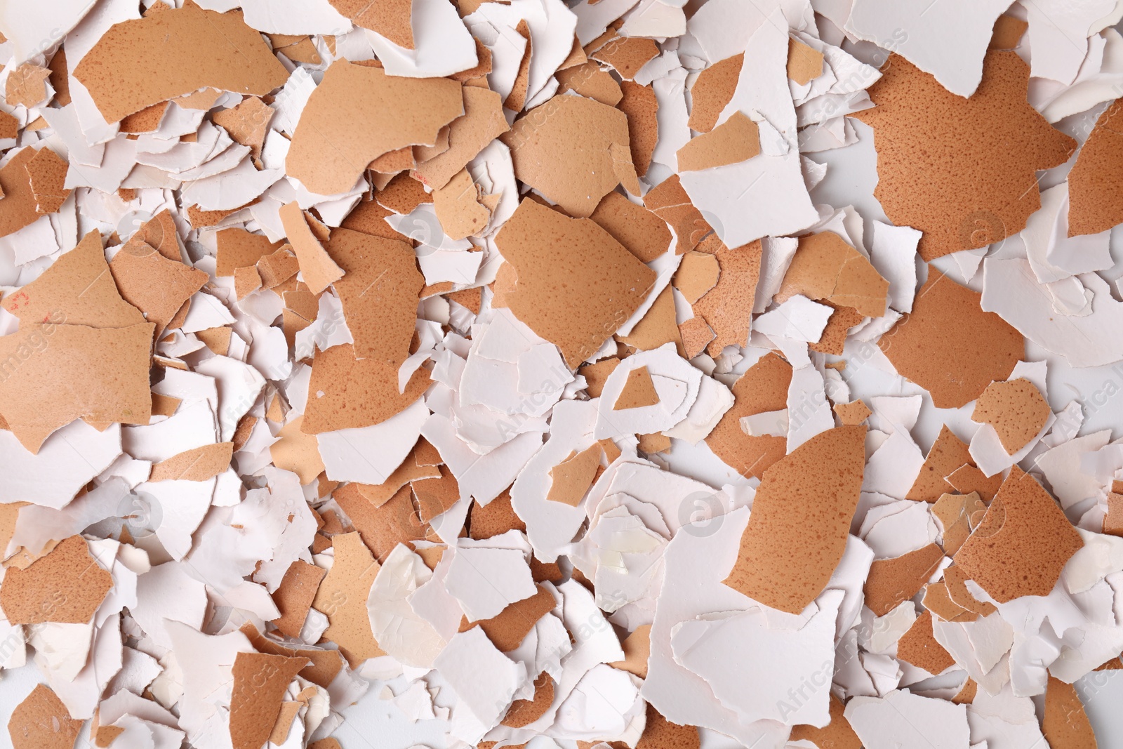 Photo of Pieces of broken eggshells as background, top view