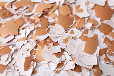 Photo of Pieces of broken eggshells as background, closeup