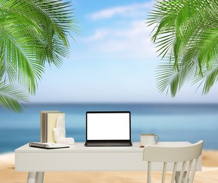 Image of Workplace at beach, distant office. Table with laptop and chair on sandy seashore. Mockup for design