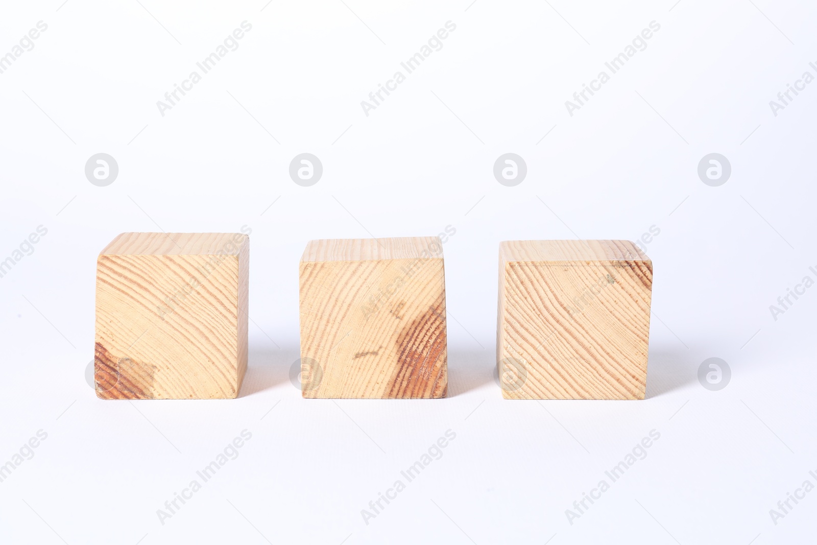 Photo of Three blank wooden cubes on white background