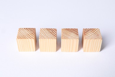 Photo of Many blank wooden cubes on white background