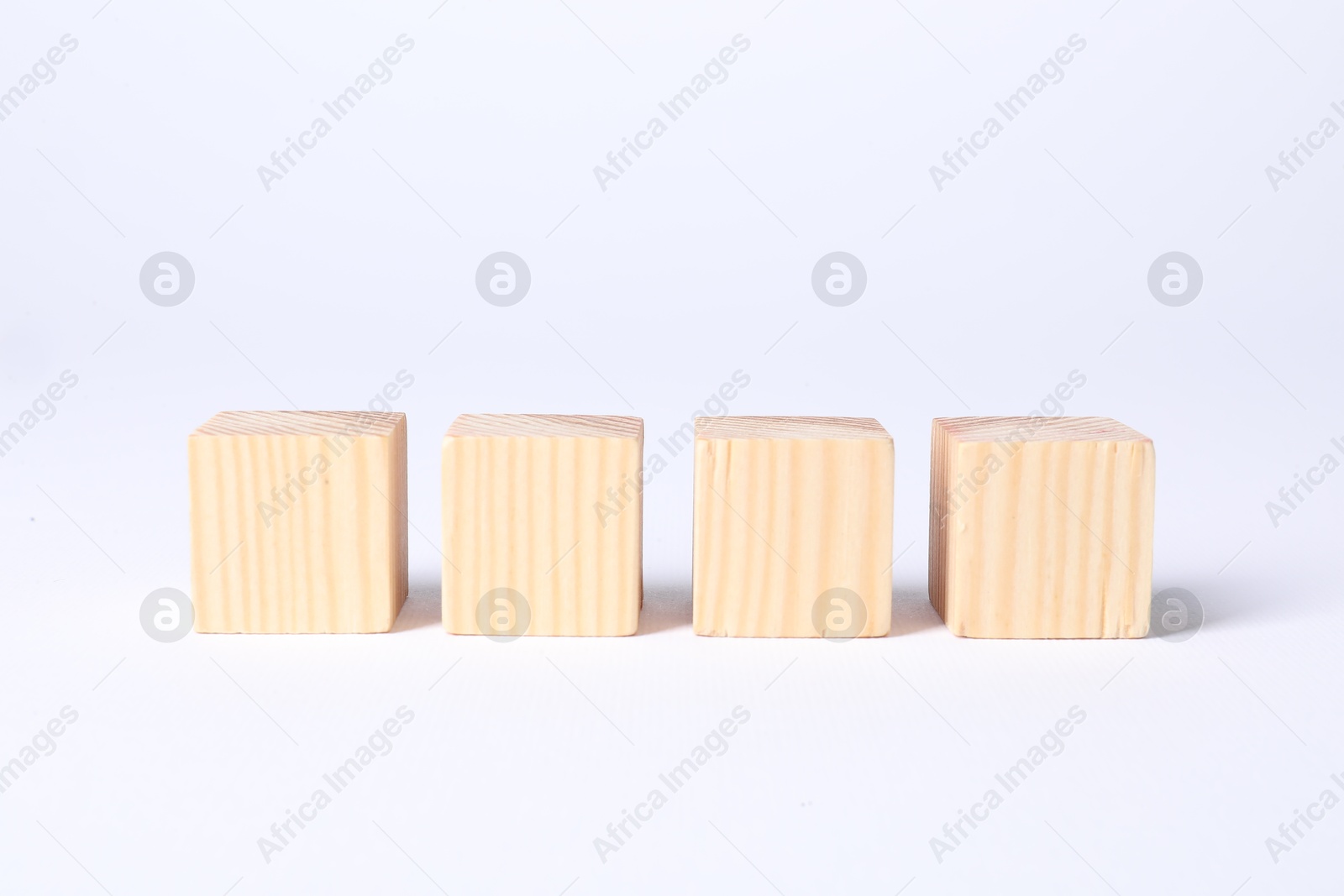 Photo of Many blank wooden cubes on white background