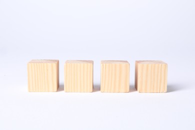 Photo of Many blank wooden cubes on white background