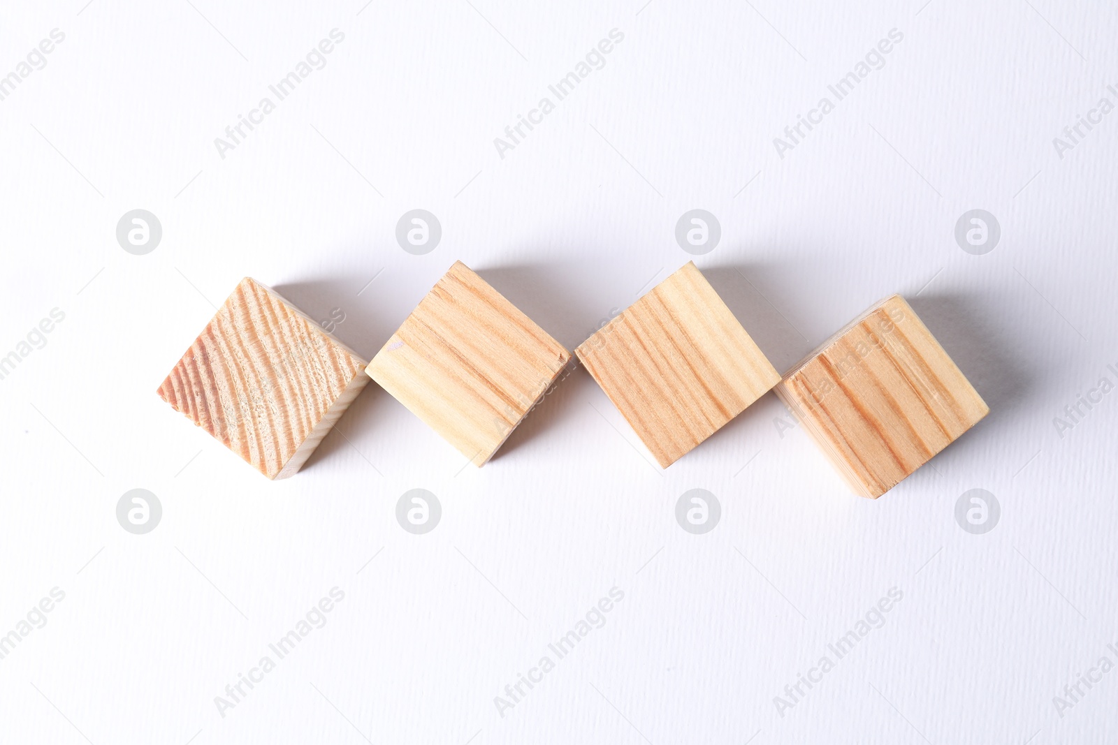 Photo of Many blank wooden cubes on white background, top view