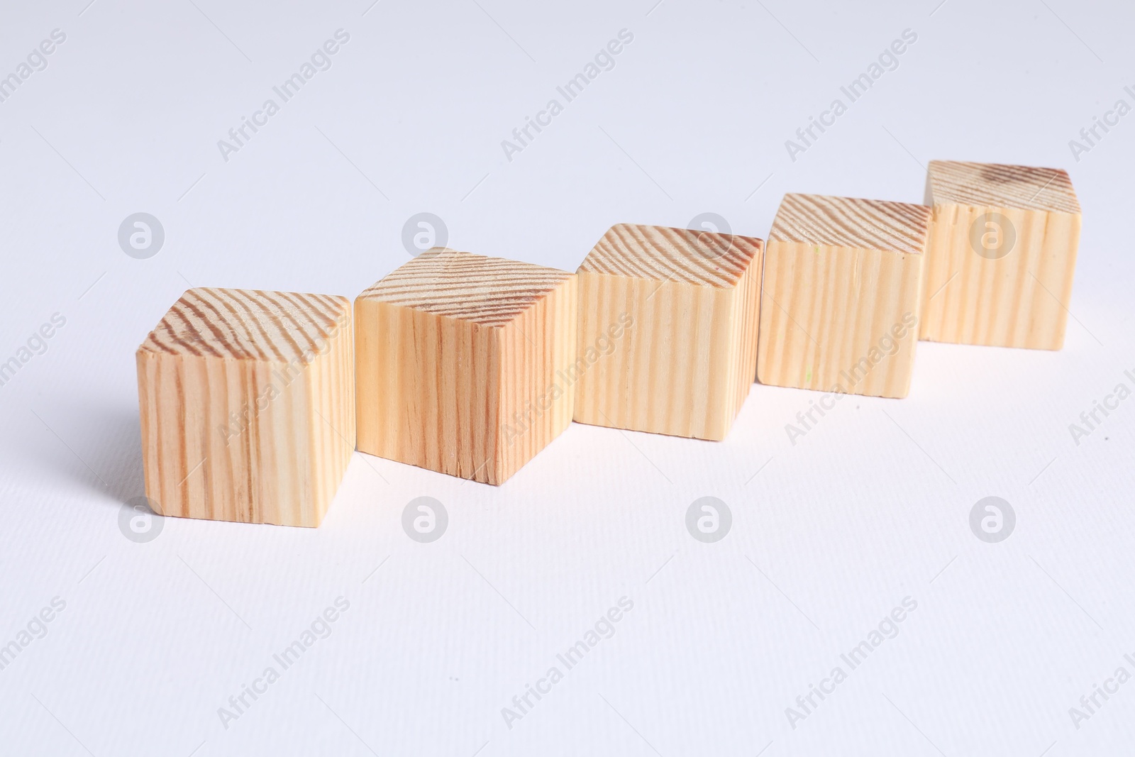 Photo of Many blank wooden cubes on white background