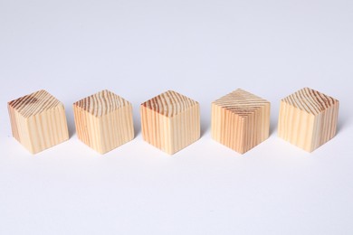 Photo of Many blank wooden cubes on white background