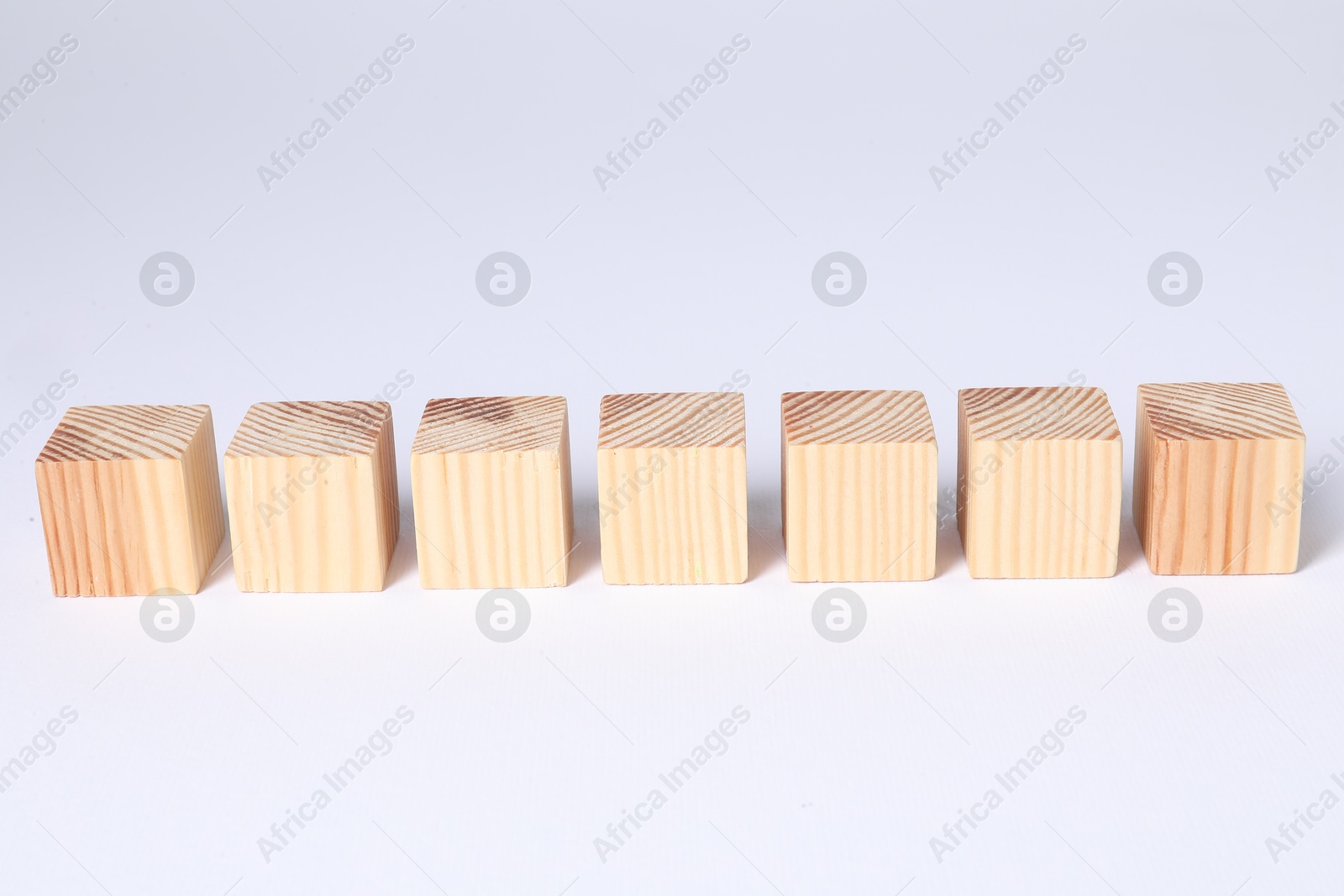 Photo of Many blank wooden cubes on white background