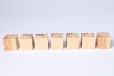 Photo of Many blank wooden cubes on white background