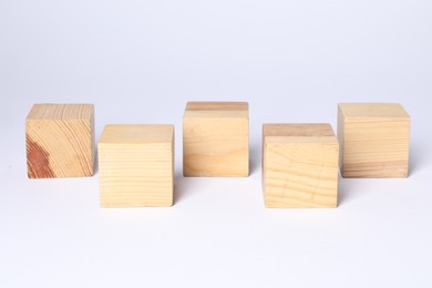 Photo of Many blank wooden cubes on white background