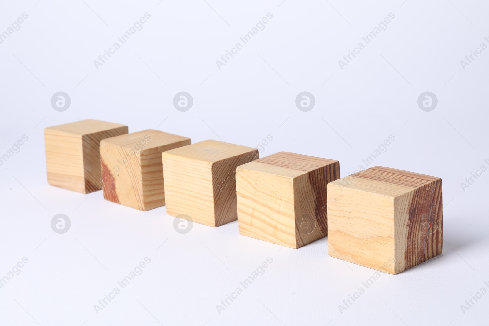 Photo of Many blank wooden cubes on white background