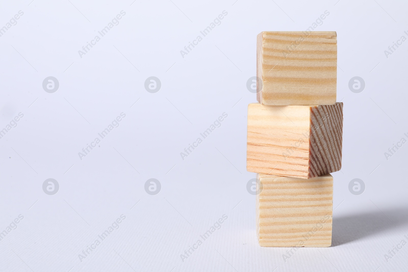 Photo of Three blank wooden cubes on white background, space for text