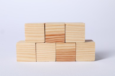 Photo of Many blank wooden cubes on white background