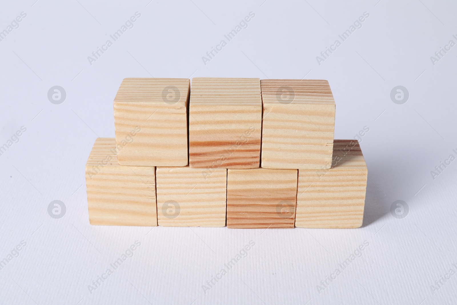 Photo of Many blank wooden cubes on white background