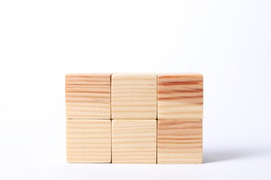 Photo of Many blank wooden cubes on white background