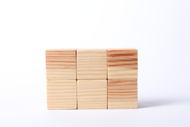 Many blank wooden cubes on white background