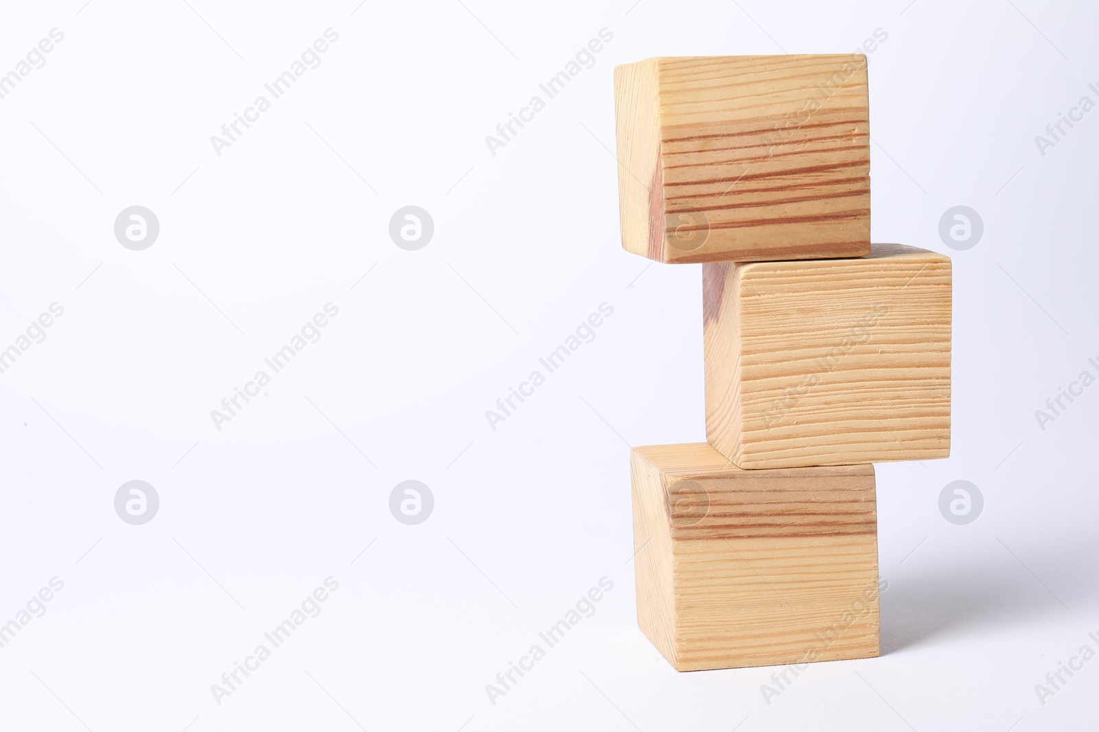 Photo of Three blank wooden cubes on white background, space for text