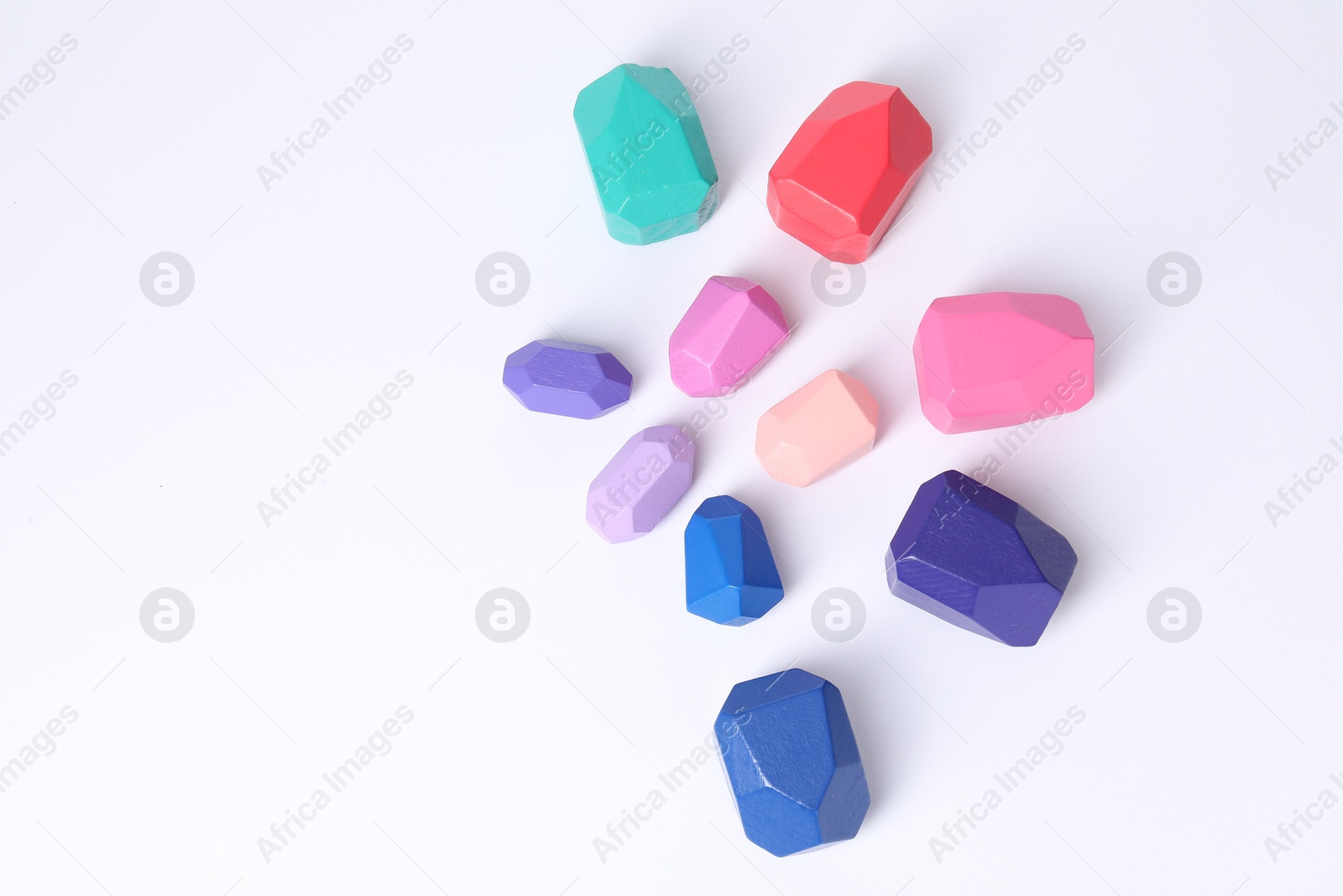 Photo of Many colorful balancing stones on white background, flat lay. Space for text