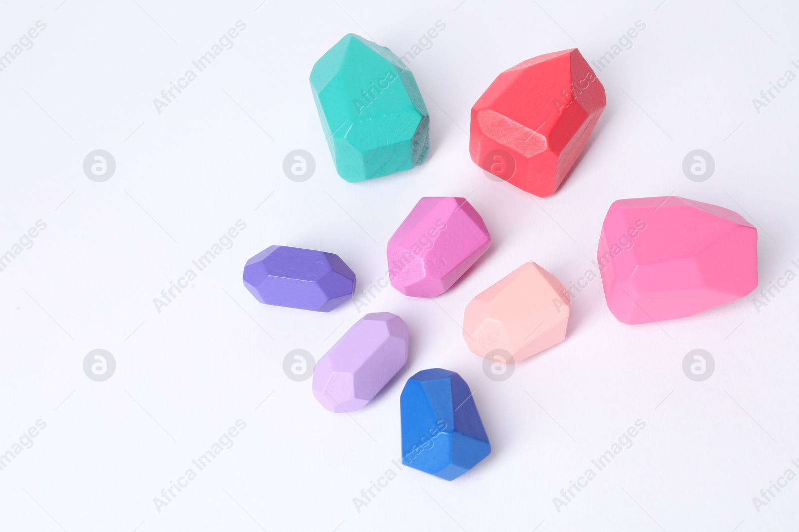 Photo of Many colorful balancing stones on white background, above view. Space for text