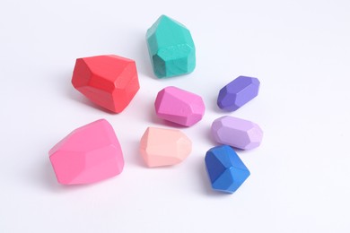 Photo of Many colorful balancing stones on white background