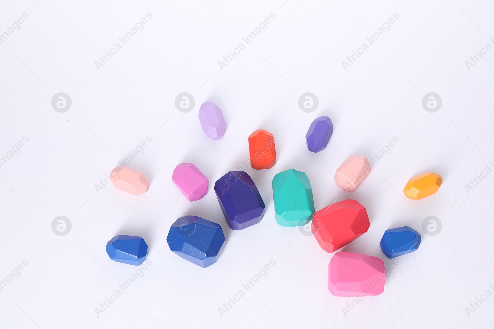 Photo of Many colorful balancing stones on white background, flat lay