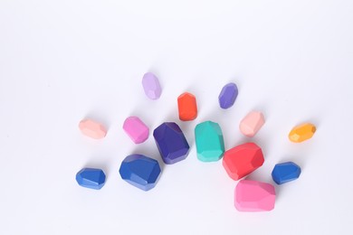 Photo of Many colorful balancing stones on white background, flat lay