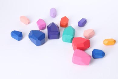 Photo of Many colorful balancing stones on white background
