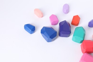 Photo of Many colorful balancing stones on white background