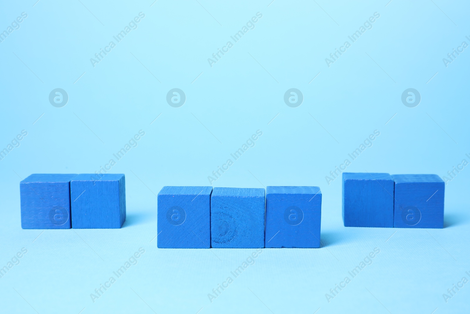 Photo of Many blank colorful cubes on light blue background