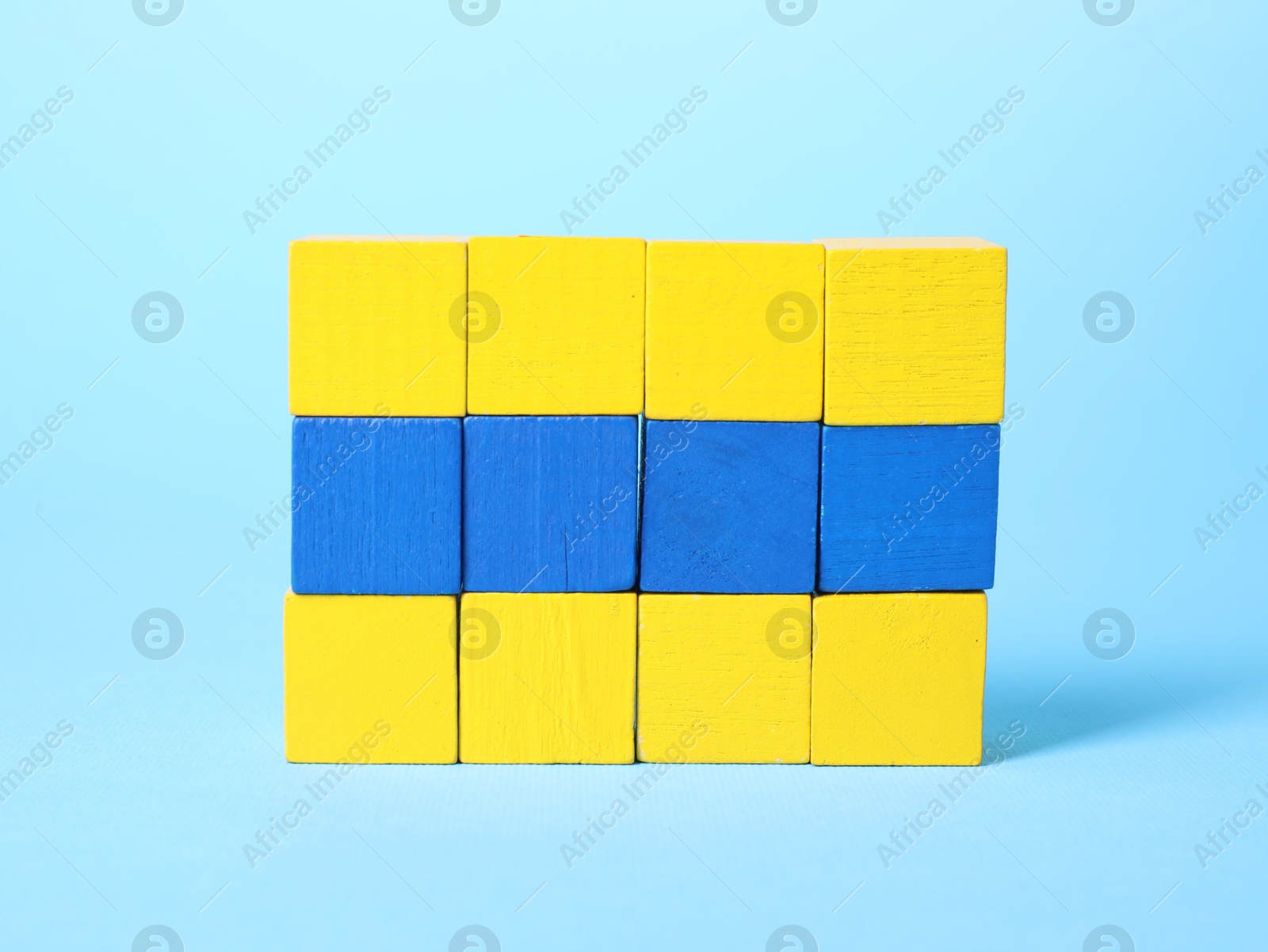 Photo of Many blank colorful cubes on light blue background